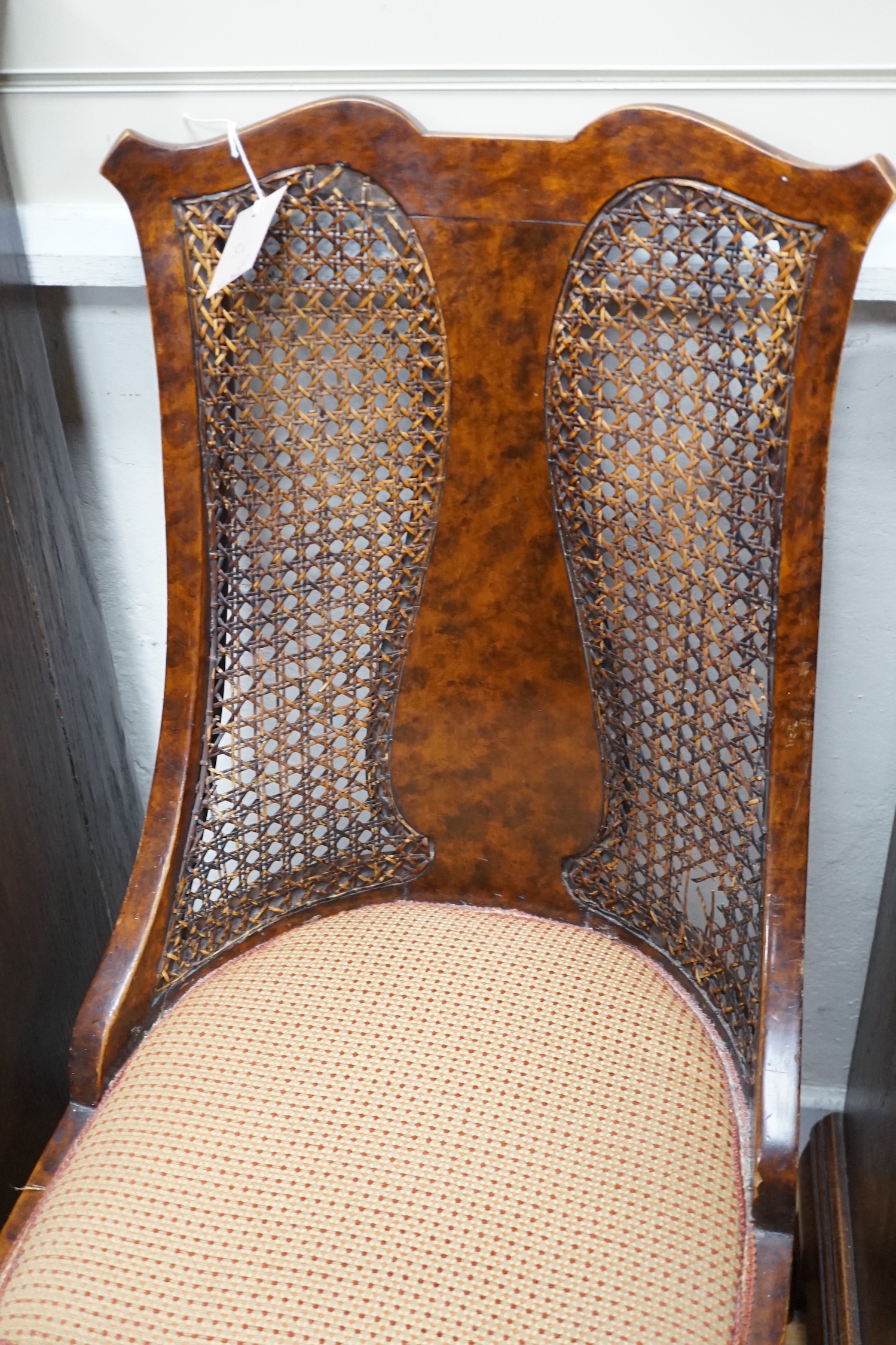 An Edwardian mahogany nursing chair and a 1930's caned walnut occasional chair
